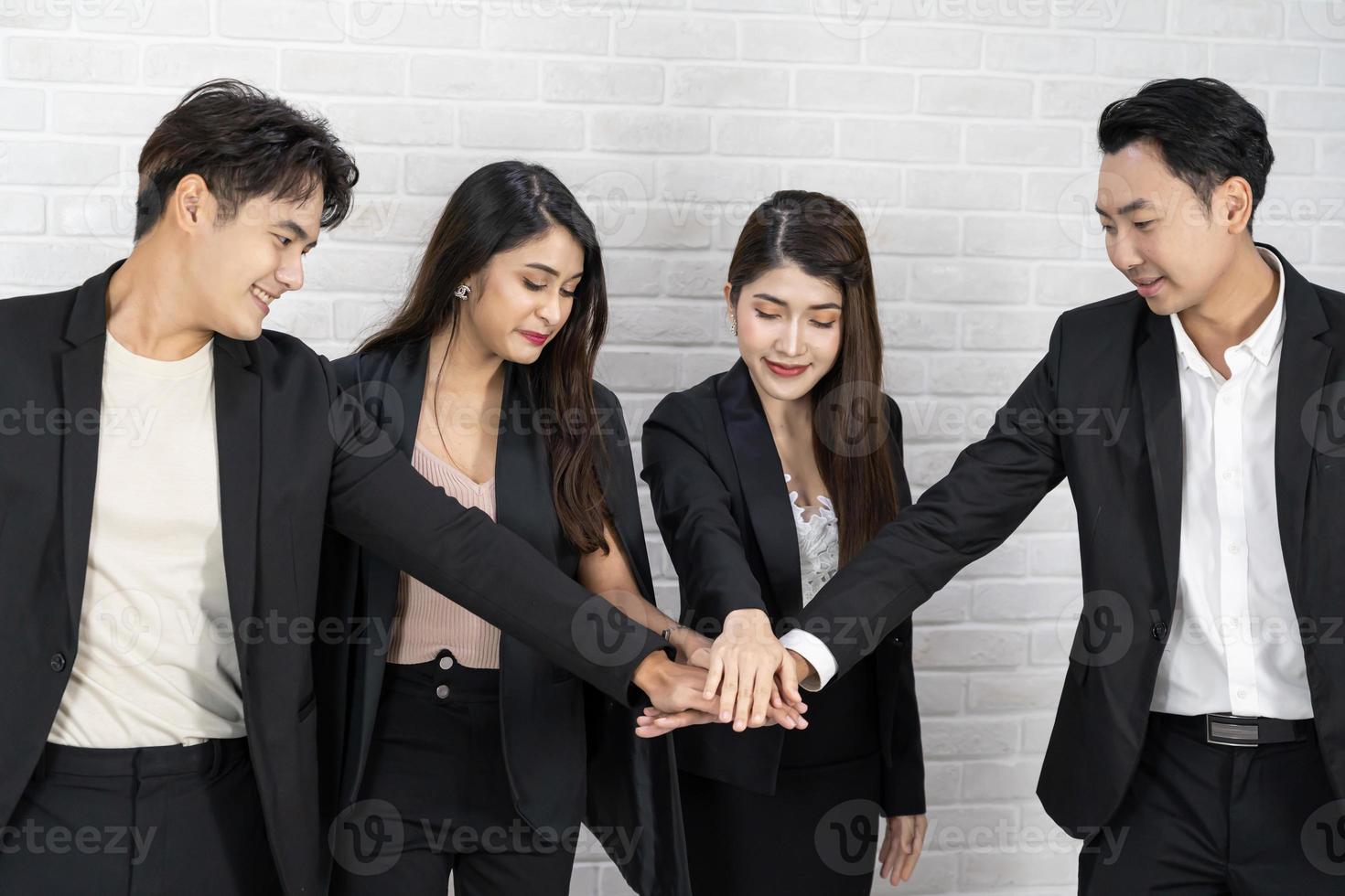 Teamwork friendship group brainstorming togetherness. Diversity business partner people teamwork holding hands together power of tag team. happy smiling colleagues with name tags stacking hands. photo