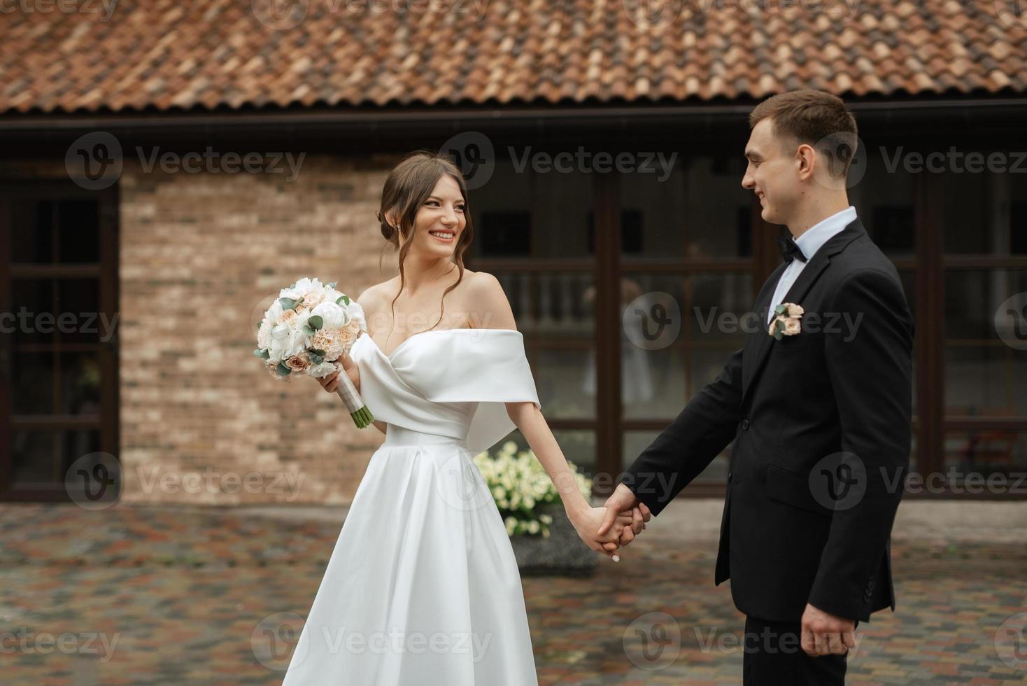 young couple bride and groom in a white short dress photo