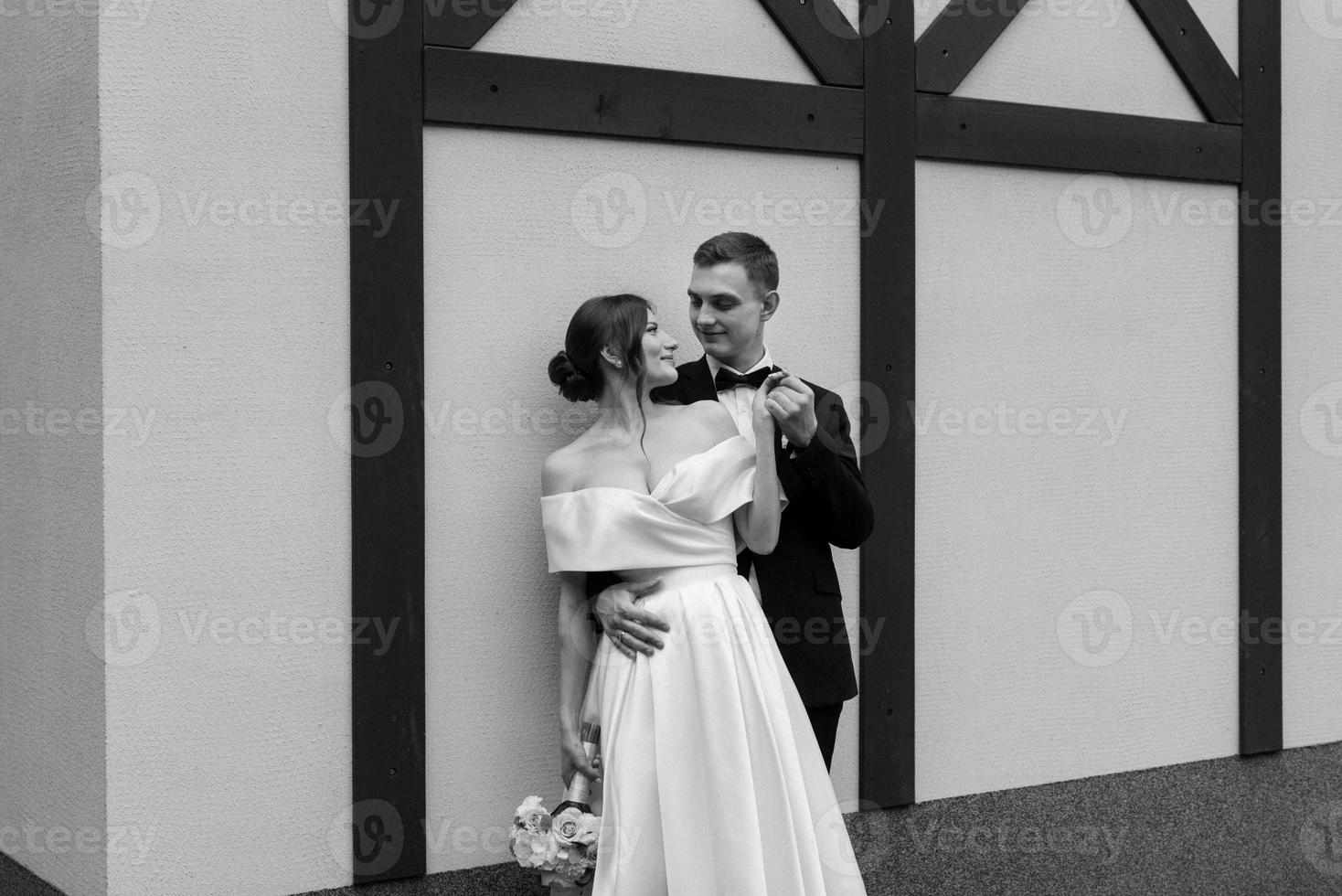 young couple bride and groom in a white short dress photo