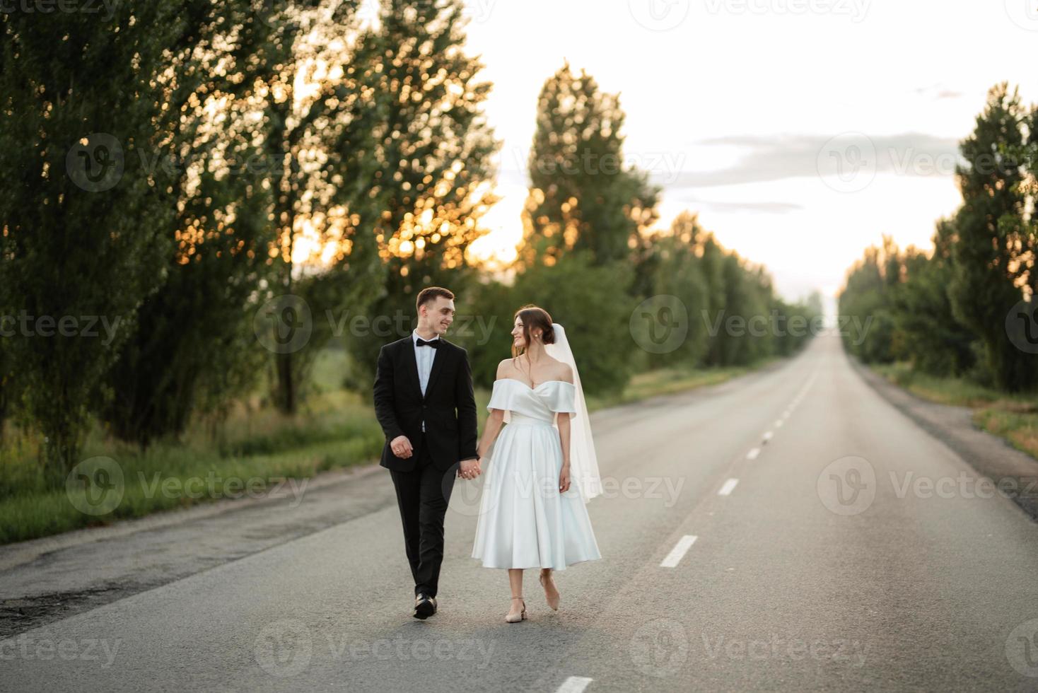 young couple bride and groom in a white short dress photo