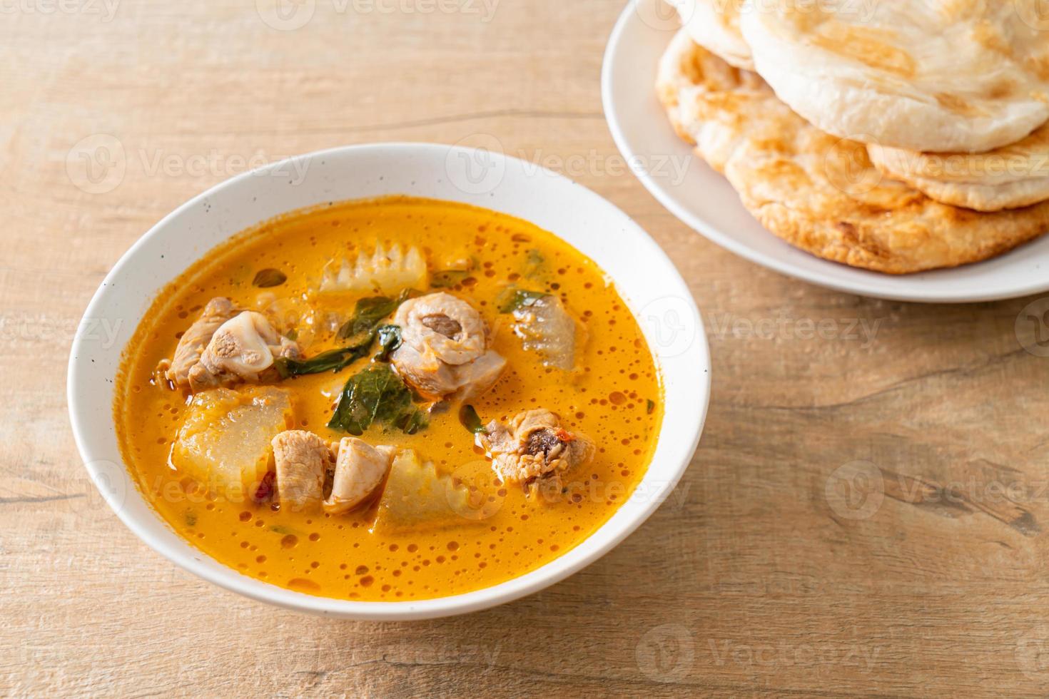 Chicken curry soup with roti photo