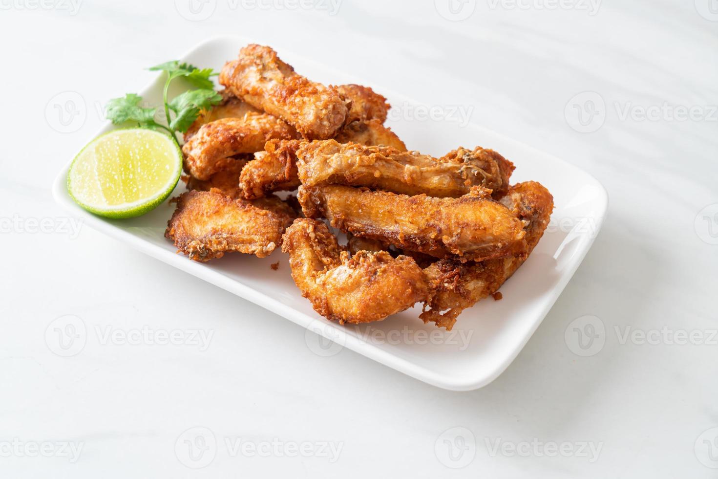 Fried Snapper Belly on white plate photo