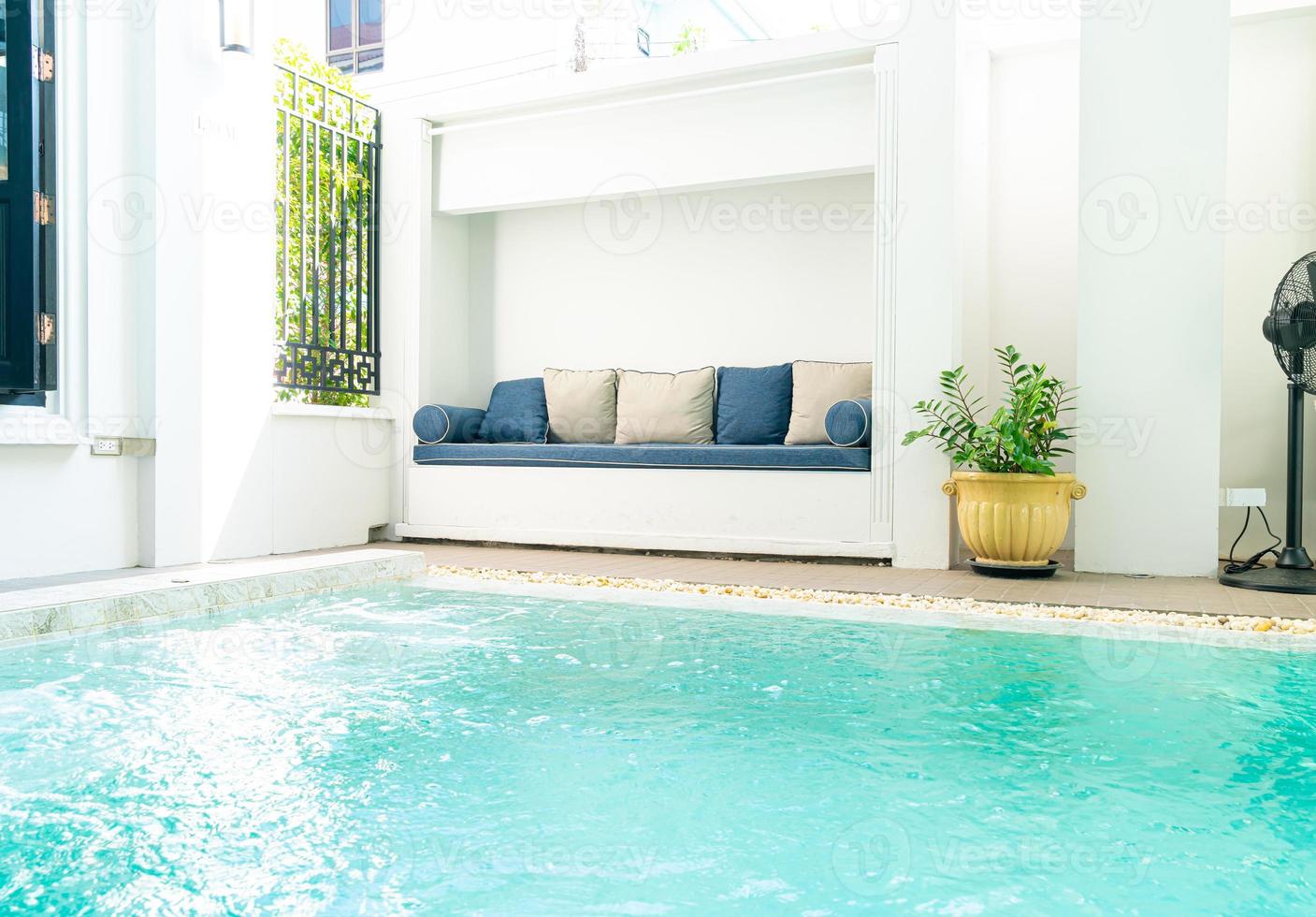 comfortable pillow on sofa around swimming pool photo