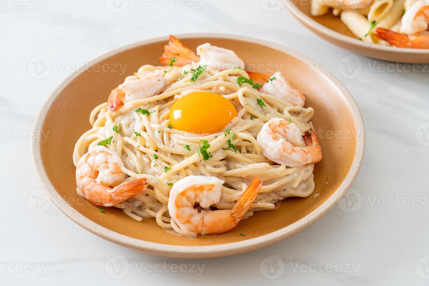 spaghetti white cream sauce with shrimps and egg yolk photo