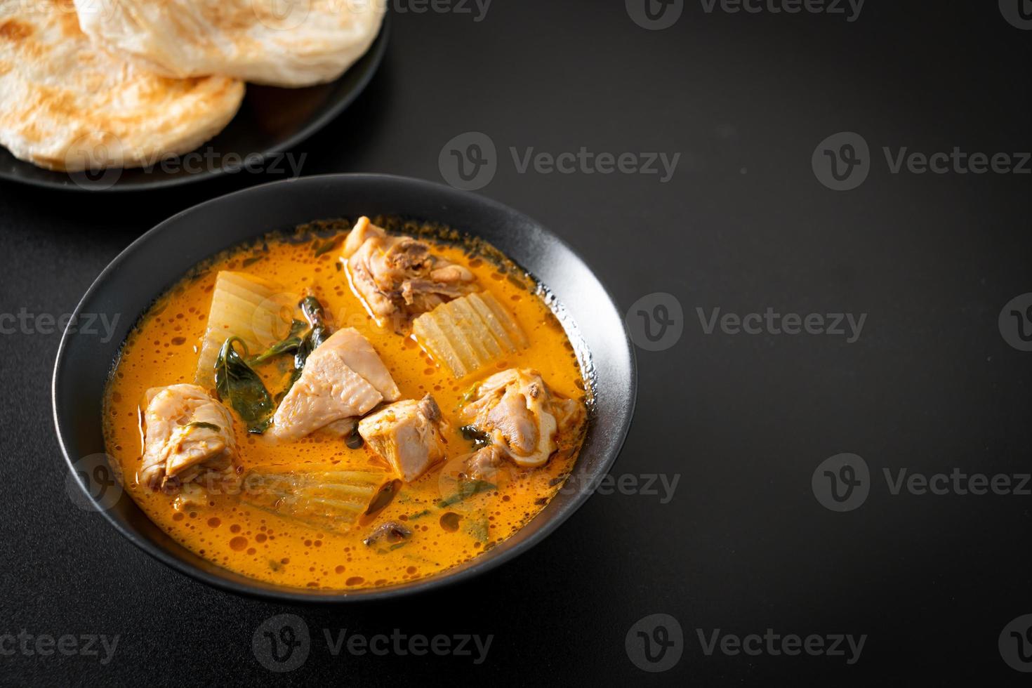 Chicken curry soup with roti photo