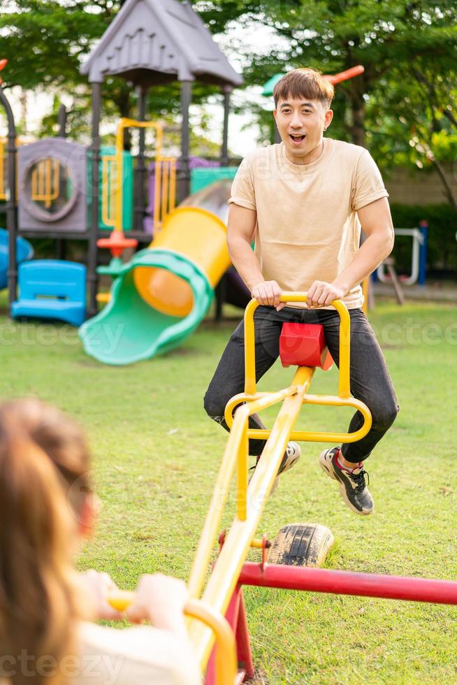 Asian couple love play seesaw photo