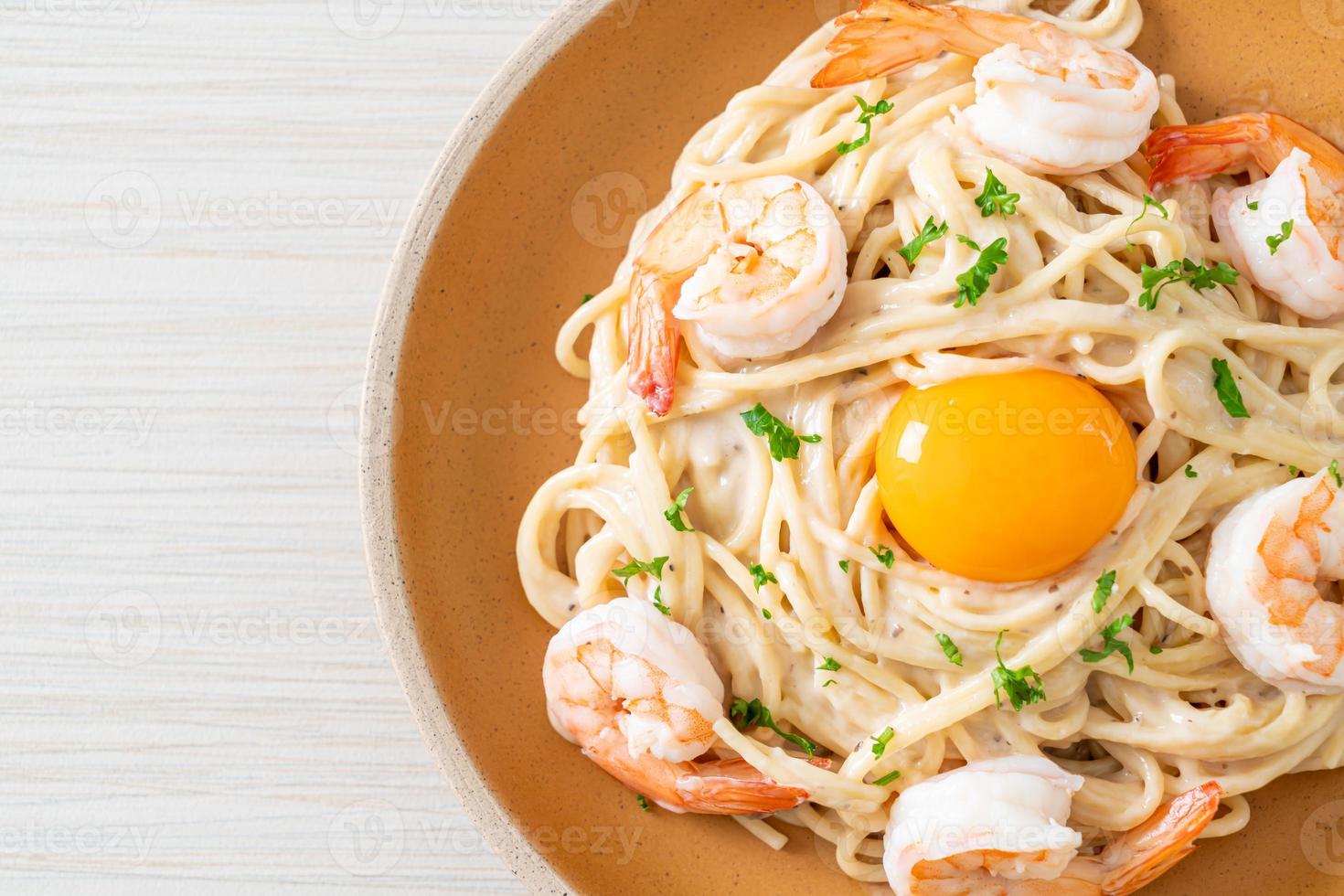 spaghetti white cream sauce with shrimps and egg yolk photo