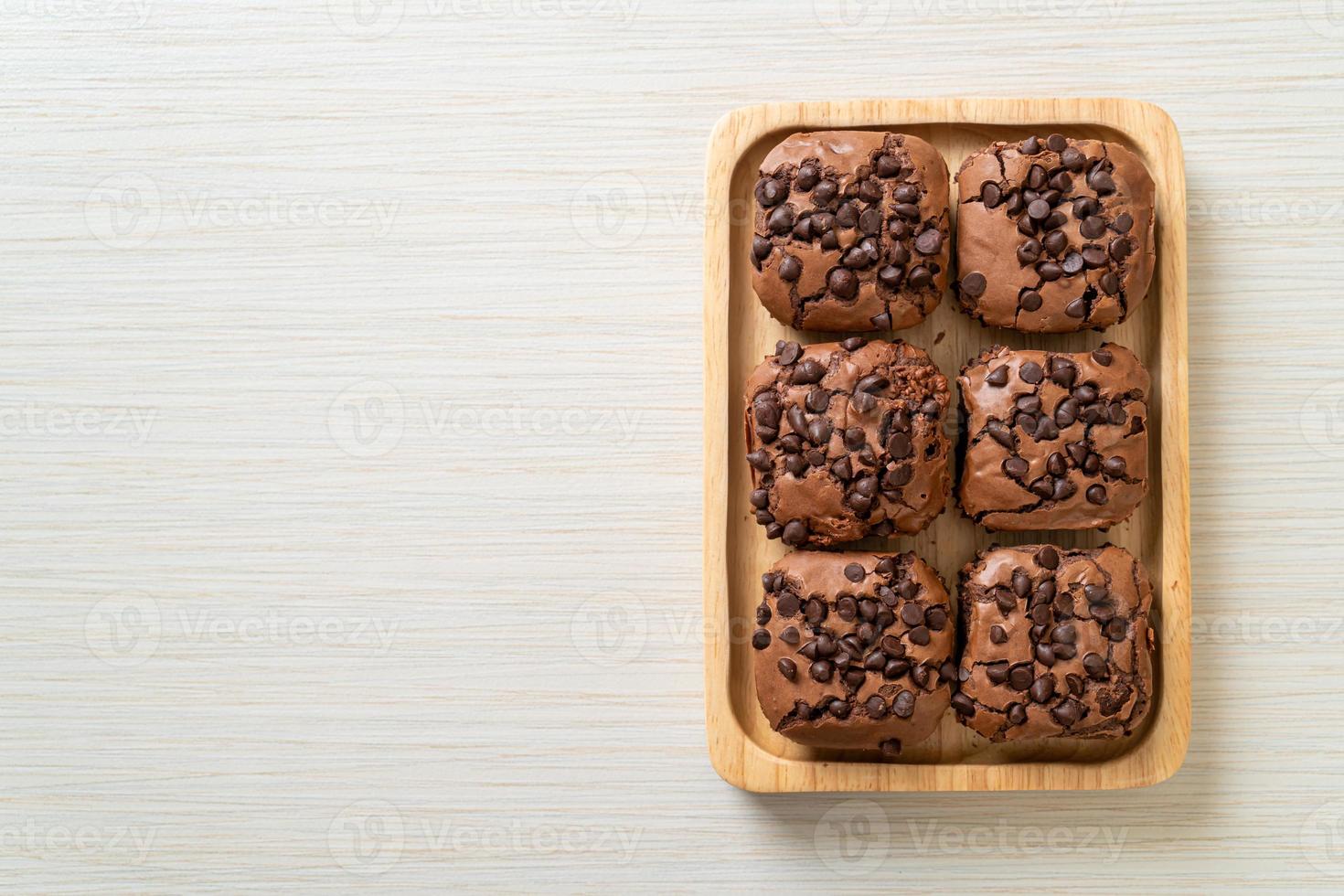 dark chocolate brownies topped by chocolate chips photo