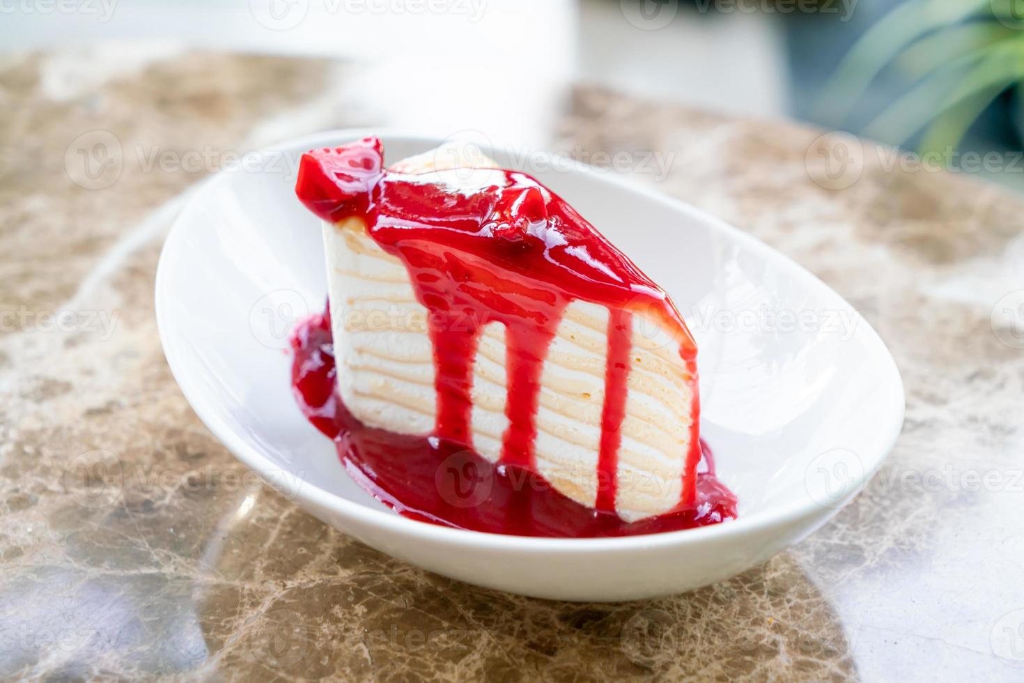 vanilla crepe cake with raspberry and strawberry sauce photo