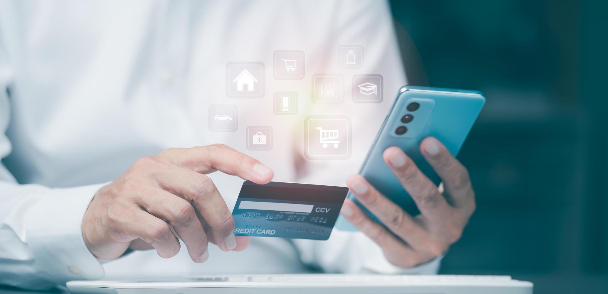 Young businessman using credit card to make financial transactions via smartphone, payment concept with wireless communication technology, focus on consumer safety and cashlessness. photo