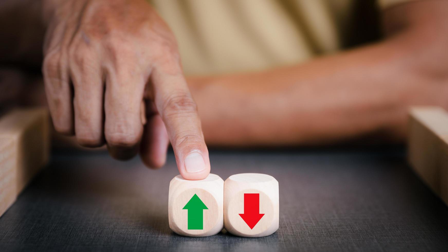 Businessman pointing to a wooden block with green arrow It represents business growth, creative leadership and a distinct business idea. Developing an organizational strategy towards innovation photo