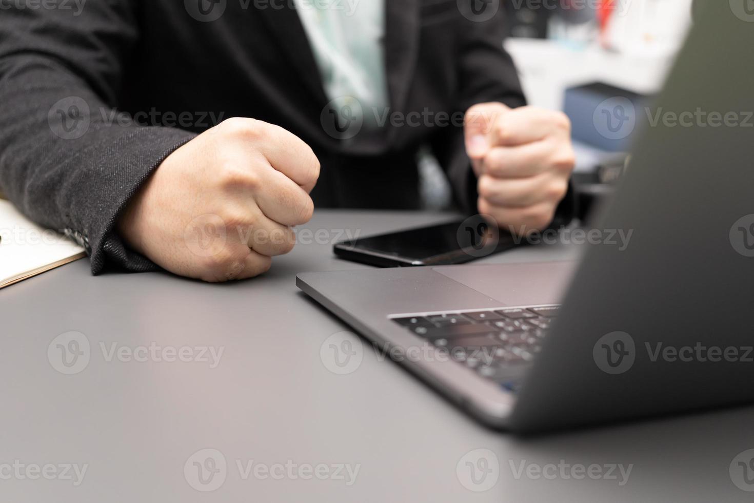 Man banging his fist on the table. showing first. Businessman hitting table with the clenched fist. One hand clenched fist to illustrate anger or determination photo