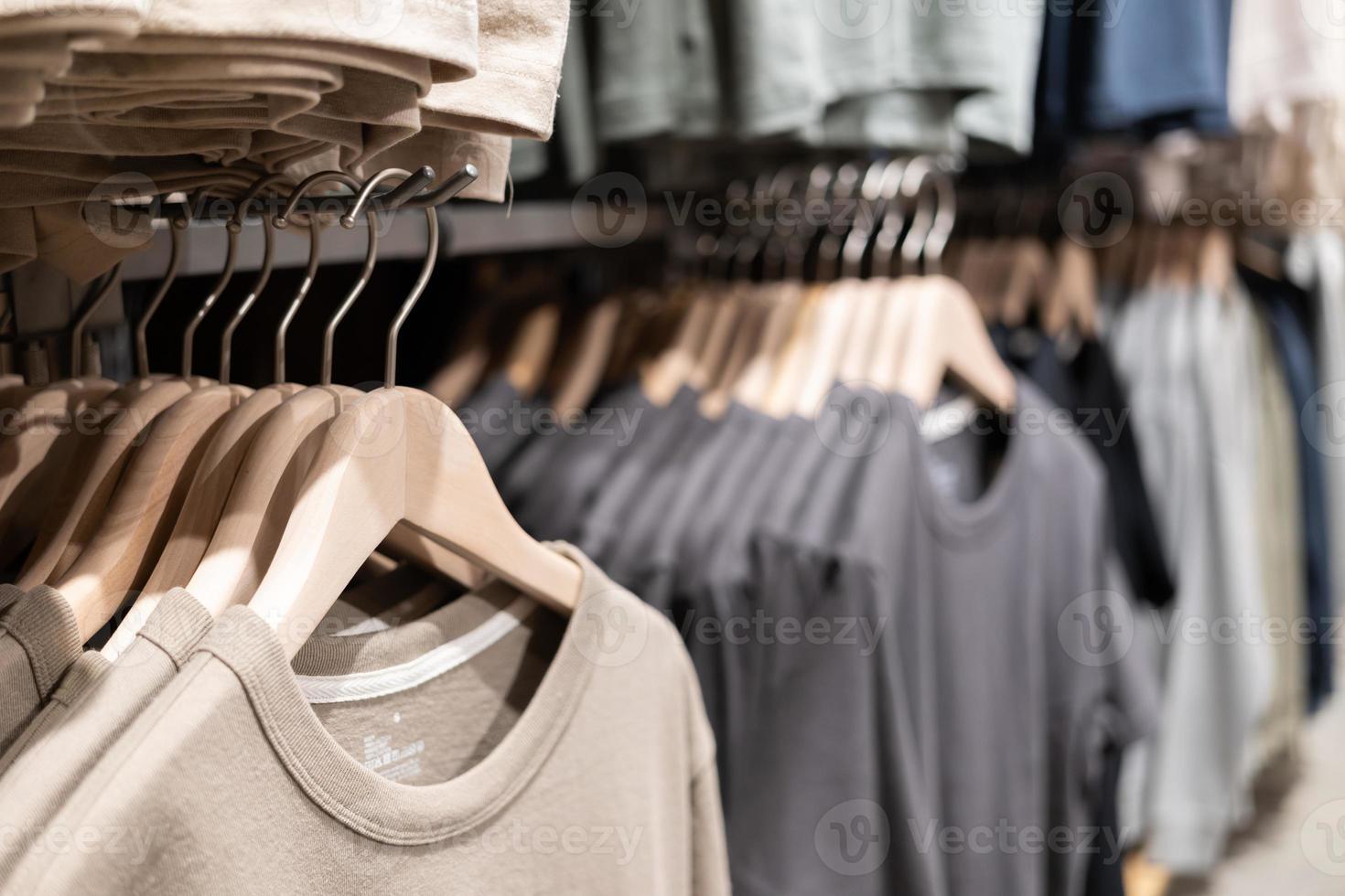 Selective focus, Fashion , clothes concept ,Clothes or pants many colors hang on a shelf in a designer clothes store. Lots of pastel-colored photo