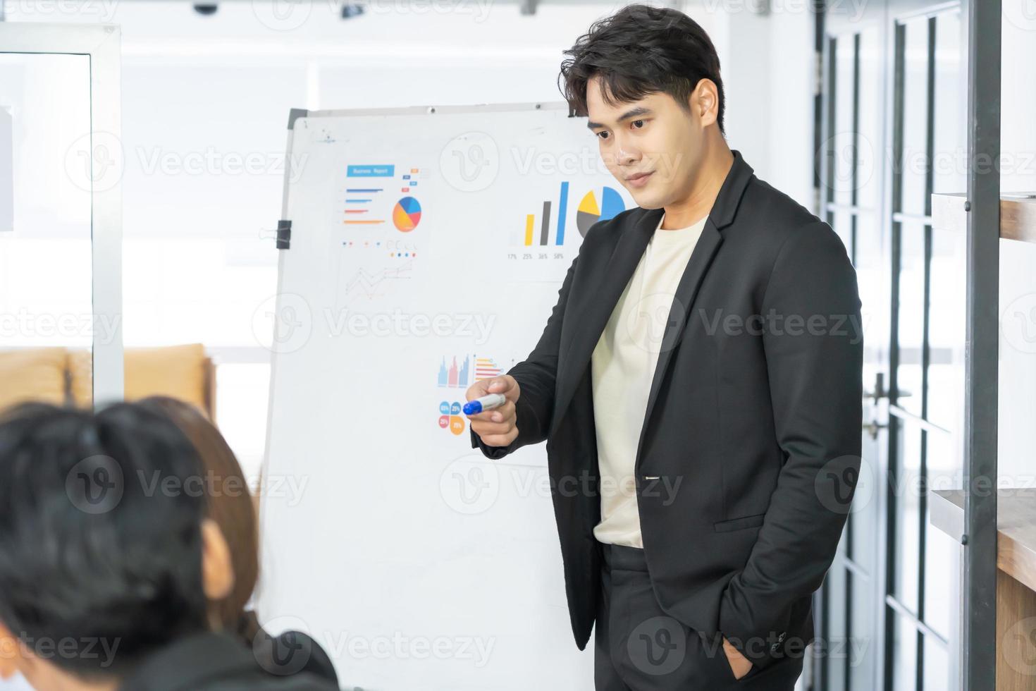 Selective Focus. Business presentation. project manager pointing at desktop presenting statistical data, briefing diverse group of employees. demonstrates statistics. photo