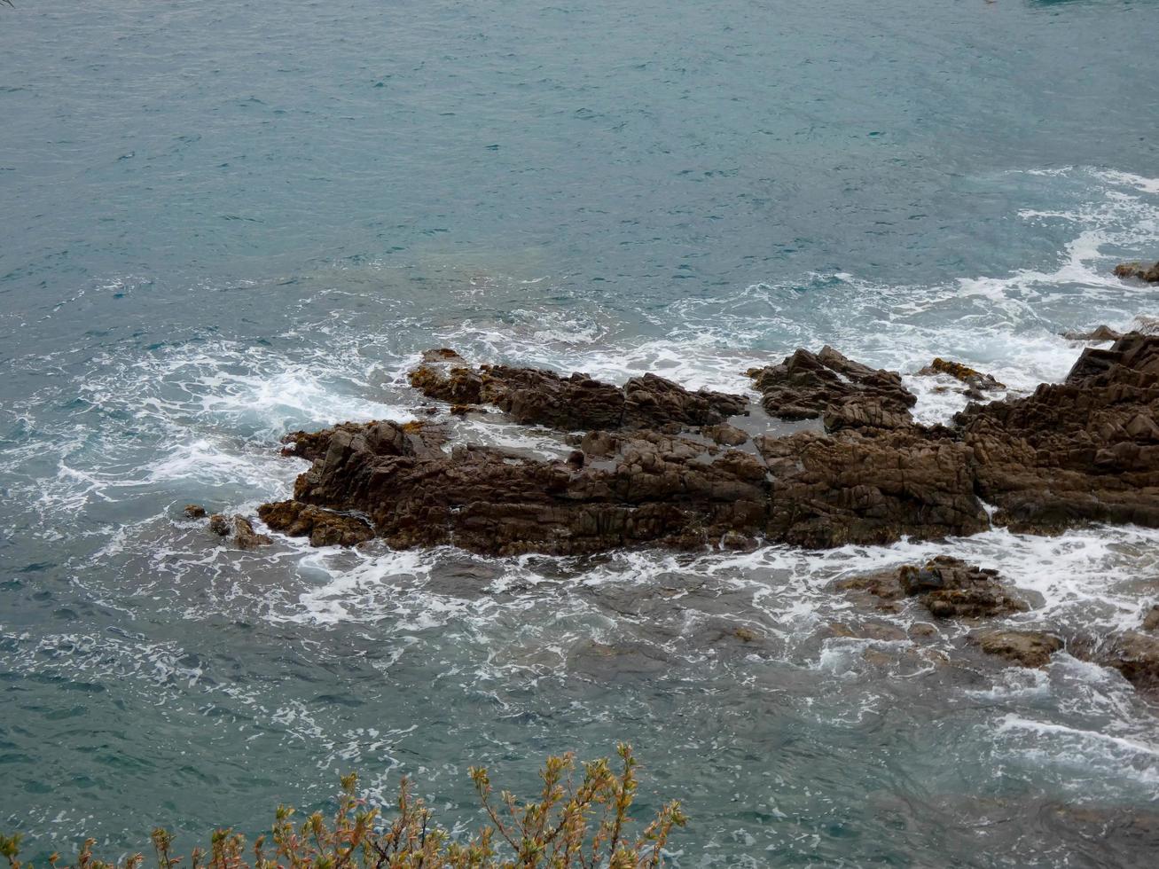 Rough sea, waves crashing against the rocks photo