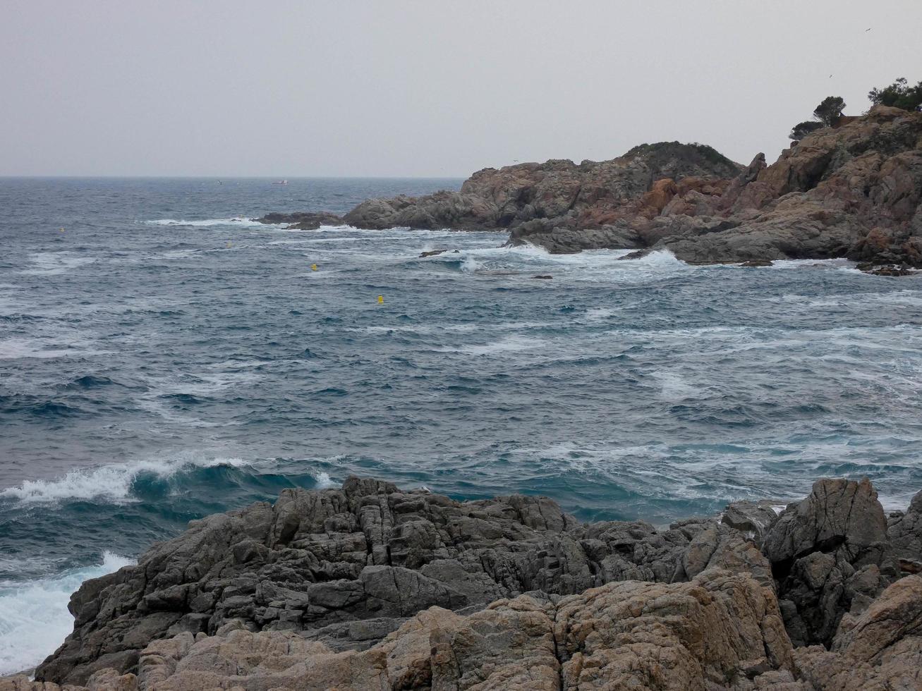 mar agitado, olas rompiendo contra las rocas foto