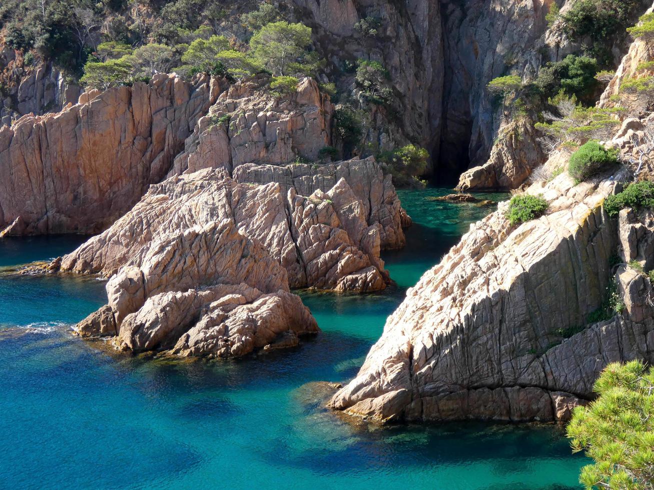 rocks and cliffs with blue sky and turquoise sea photo