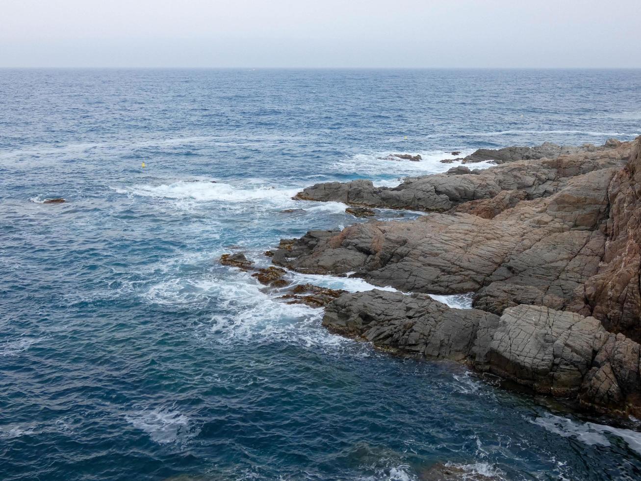 Rough sea, waves crashing against the rocks photo