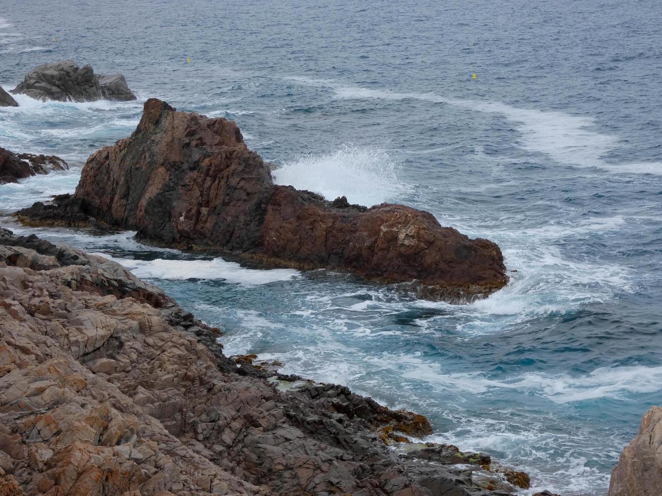 Rough sea, waves crashing against the rocks photo