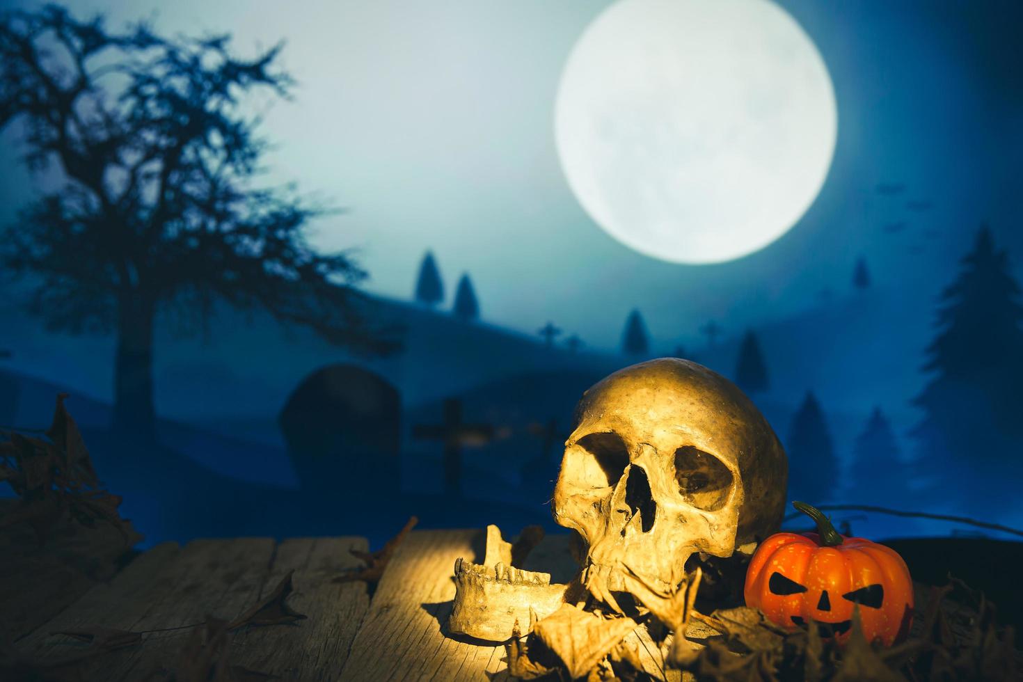 Spooky cemetery with glow halloween pumpkin photo