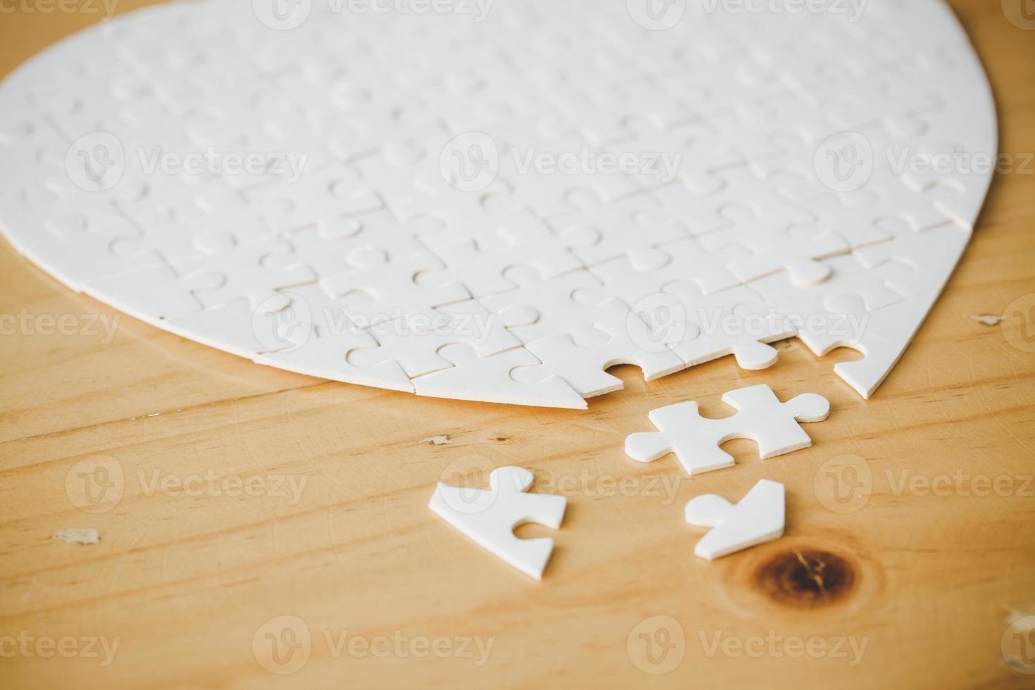 White part of jigsaw puzzle pieces on wooden table background. concepts of problem solving, business success, teamwork, Team playing jigsaw game incomplete, Texture photo with copy space for text