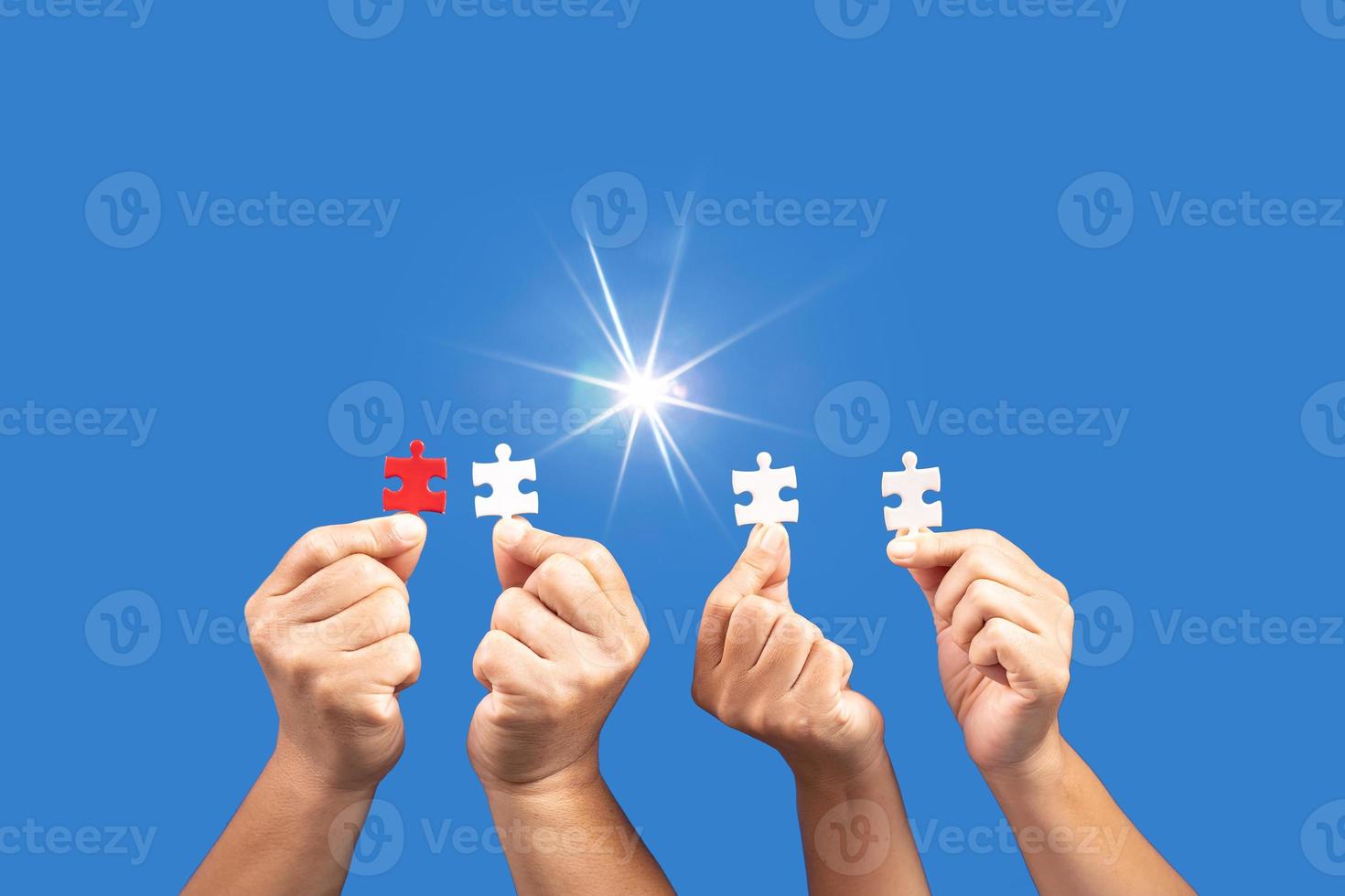 Hands holding jigsaw puzzles piece with clear blue background, success business, solution strategy, teamwork partnership concept photo