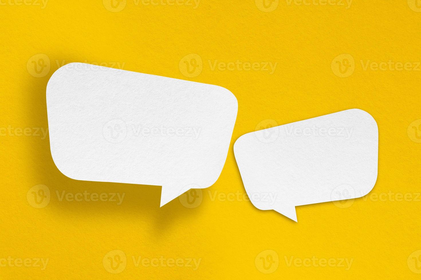 speech balloon shape white paper isolated on yellow background photo