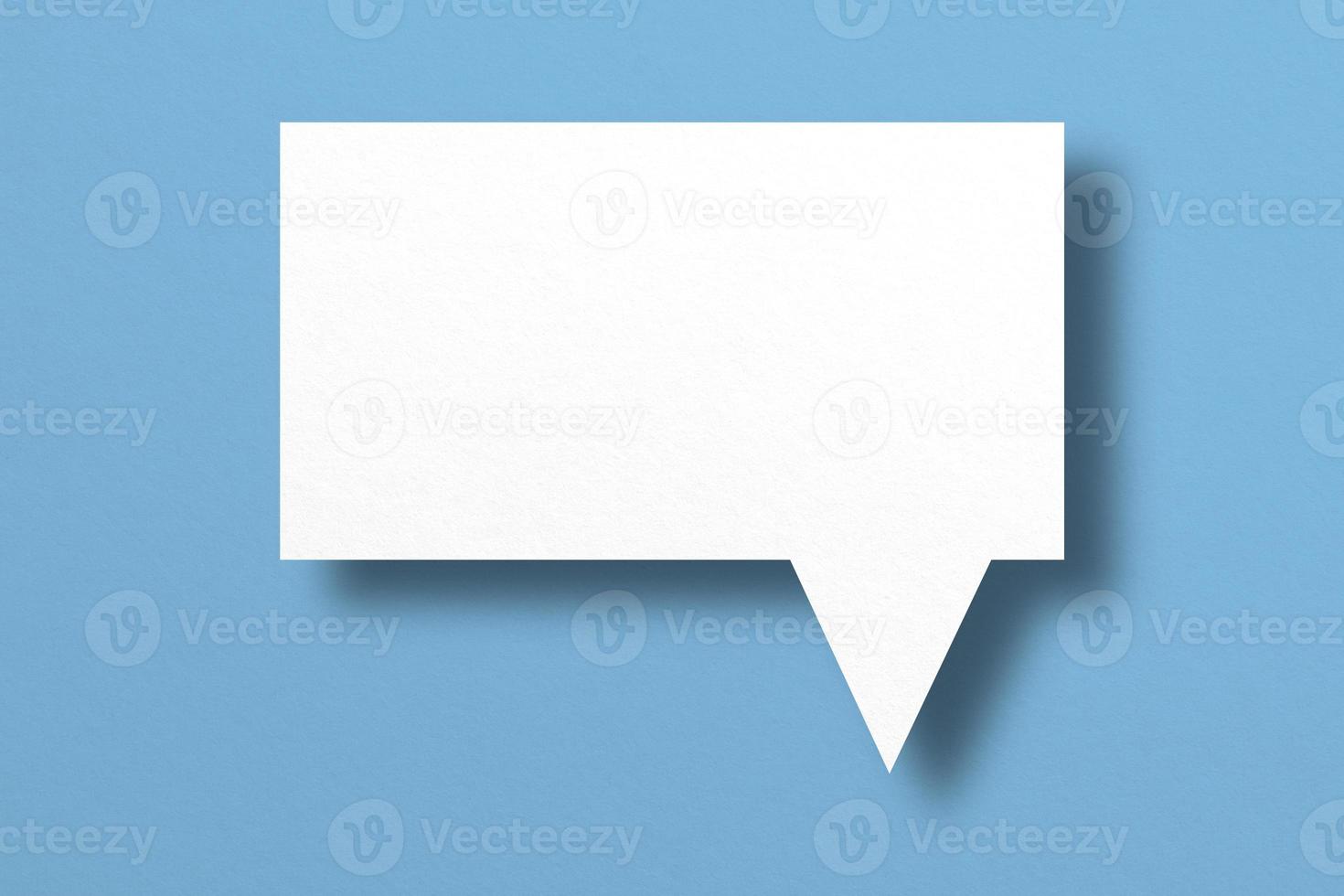 white paper with speech bubbles isolated on blue background communication bubbles photo