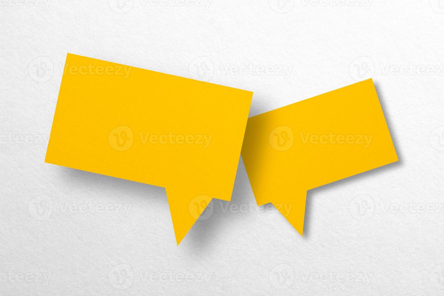 Speech balloon shaped yellow paper isolated on white background. photo
