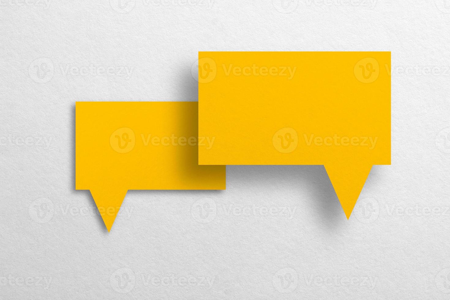 Speech balloon shaped yellow paper isolated on white background. photo