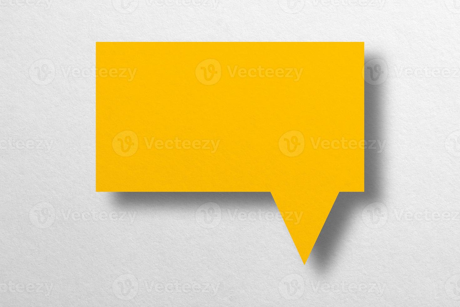 Speech balloon shaped yellow paper isolated on white background. photo