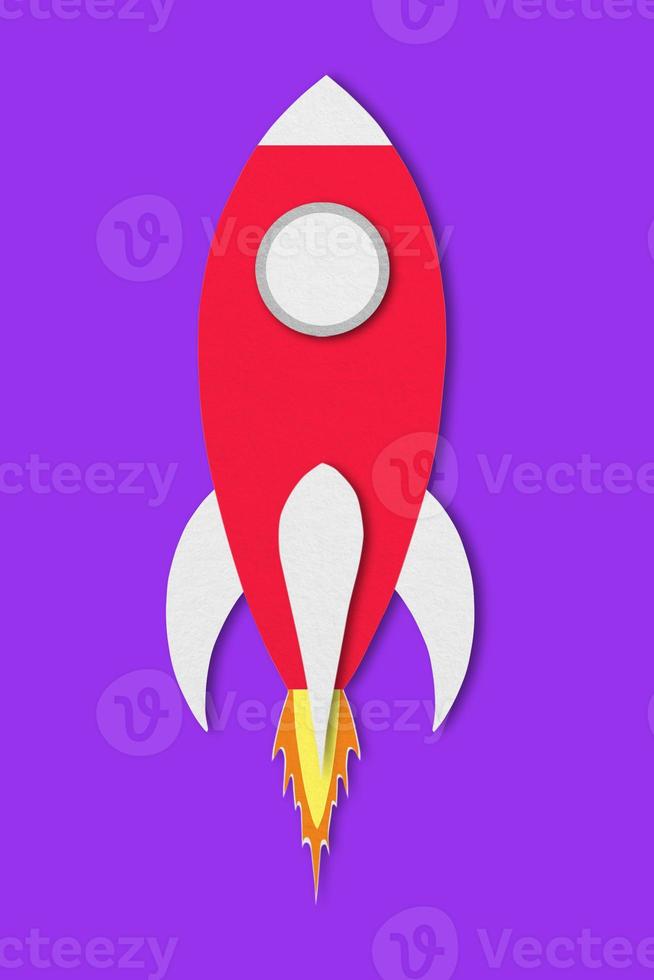 red spaceship paper isolated on purple background and clipping path design paper photo