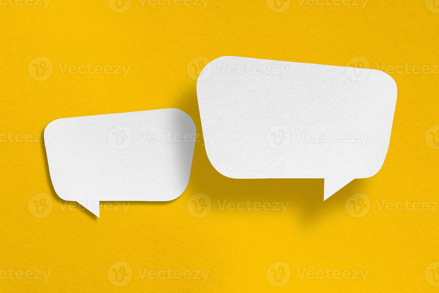 speech balloon shape white paper isolated on yellow background photo