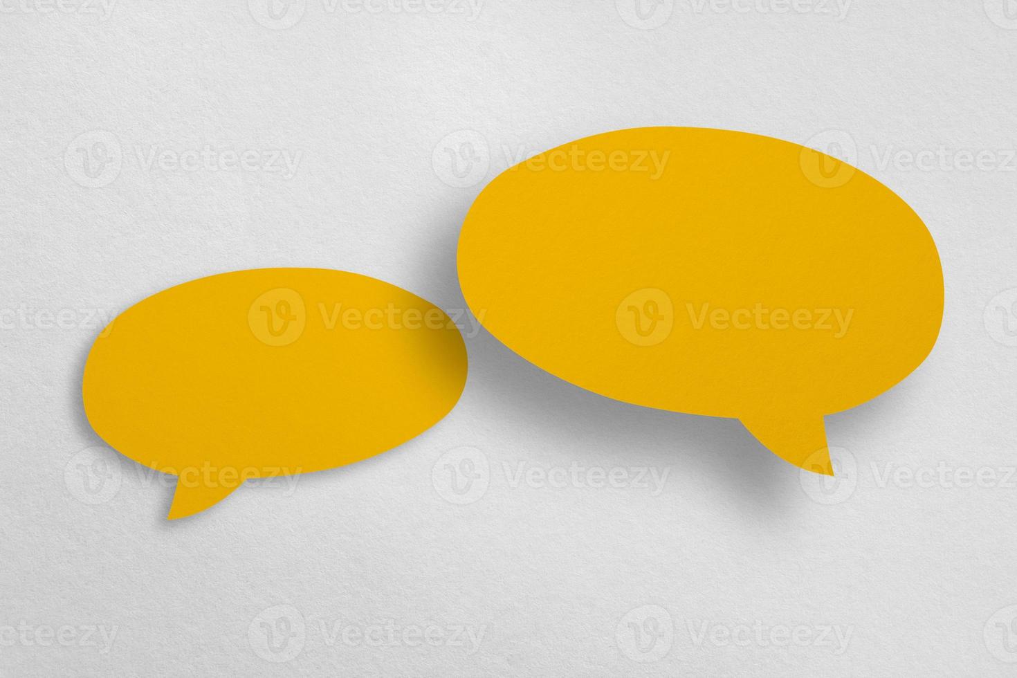 Speech balloon shaped yellow paper isolated on white background. photo