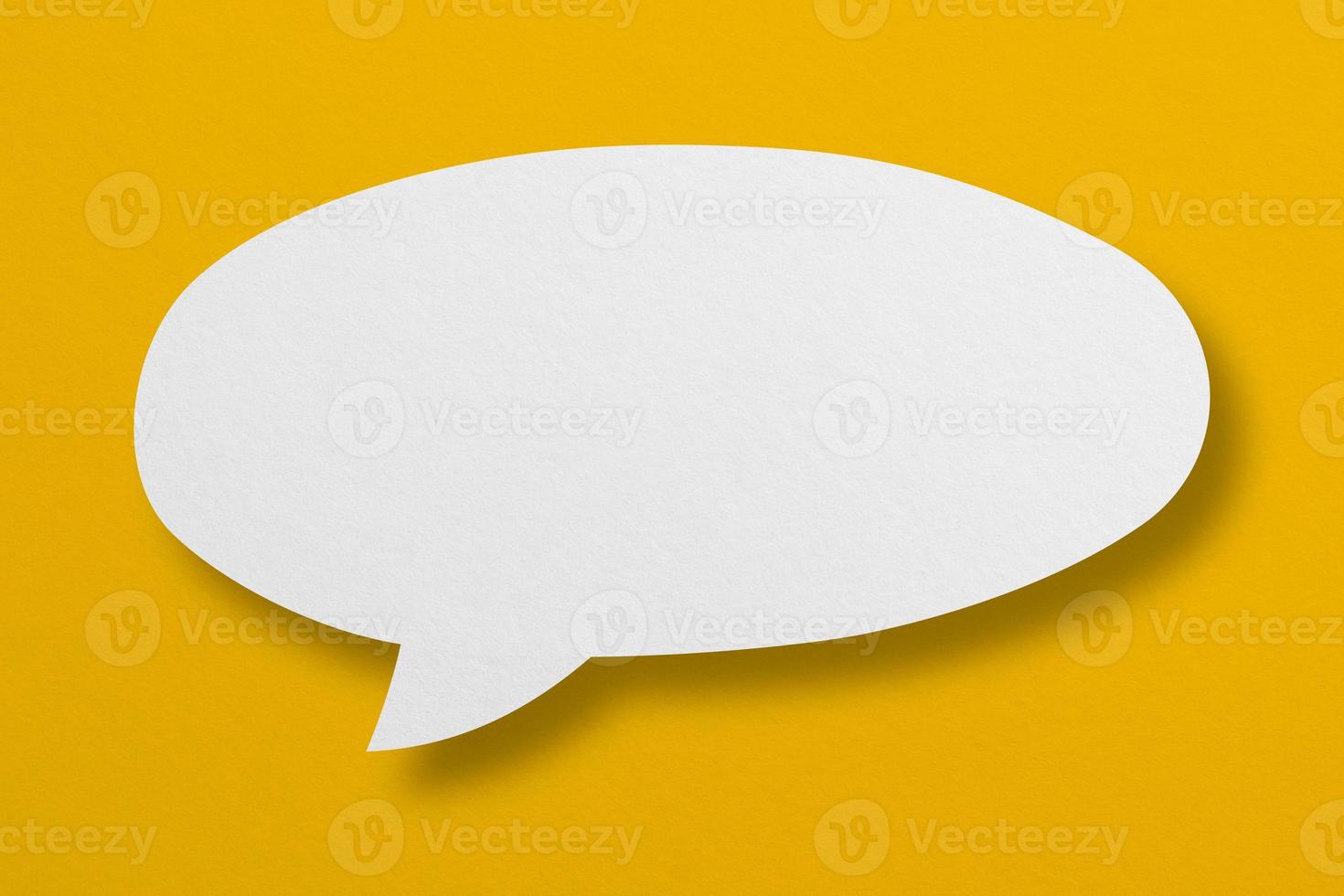 speech balloon shape white paper isolated on yellow background photo