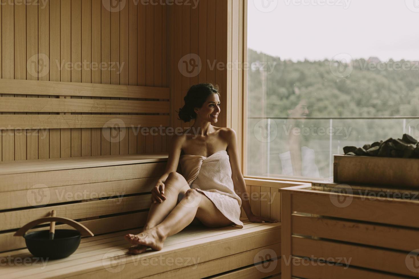 Young woman relaxing in the sauna photo