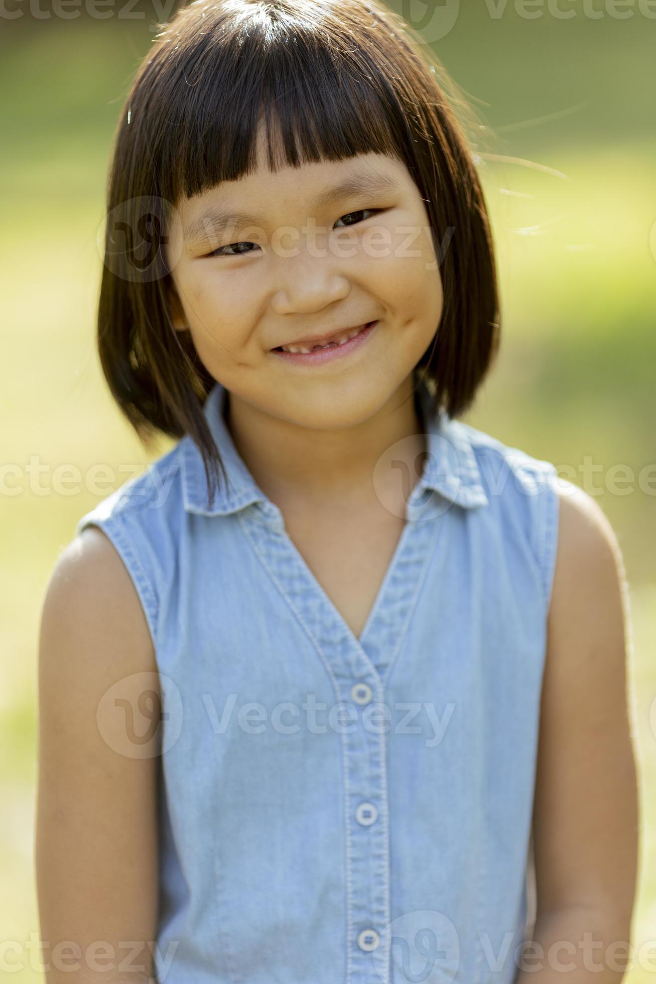 Little Korean girl standing in the park 10196357 Stock Photo at Vecteezy