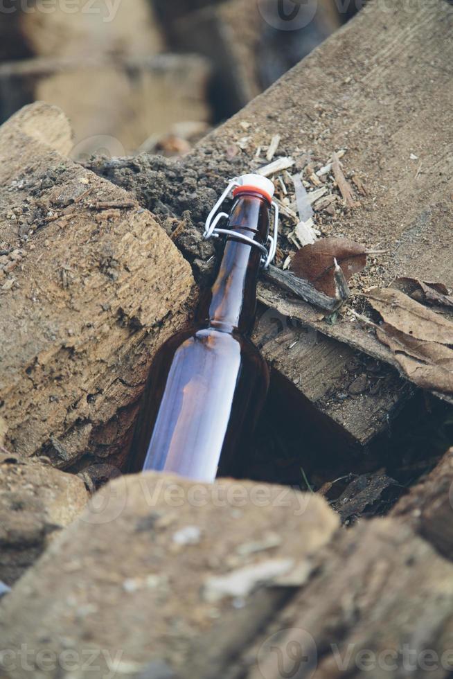 Glass bottle on wooden stack photo