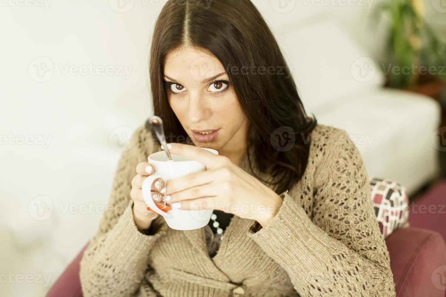 Young woman drinking tea photo