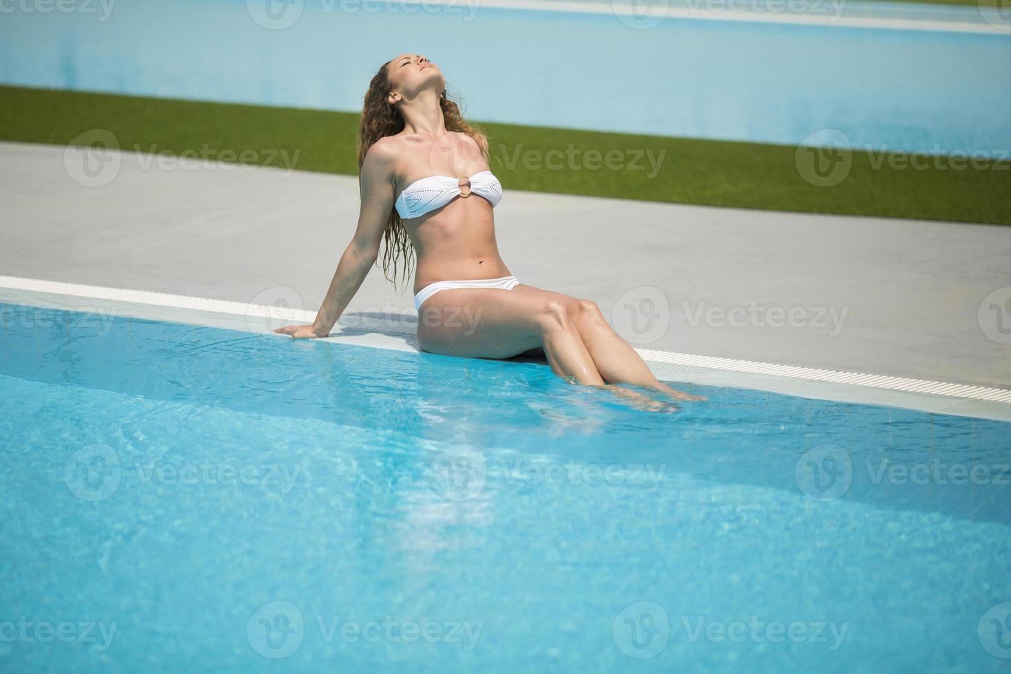 Young woman by the pool photo