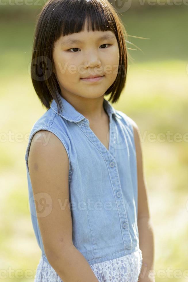 Little Korean girl standing in the park photo