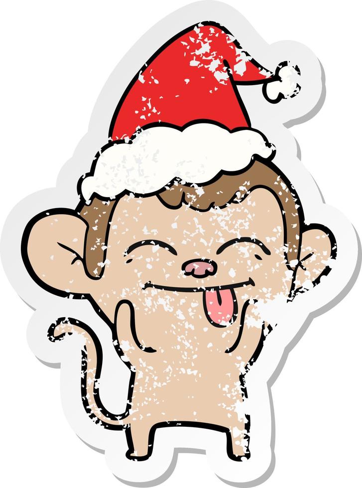 funny distressed sticker cartoon of a monkey wearing santa hat vector