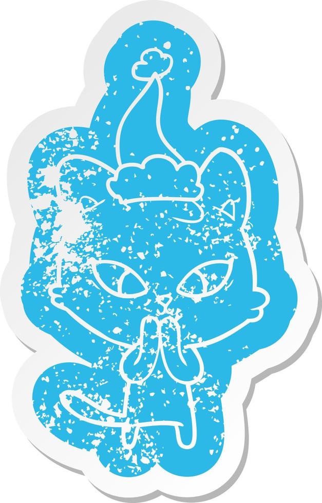 cute cartoon distressed sticker of a cat wearing santa hat vector