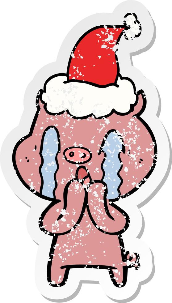 crying pig distressed sticker cartoon of a wearing santa hat vector