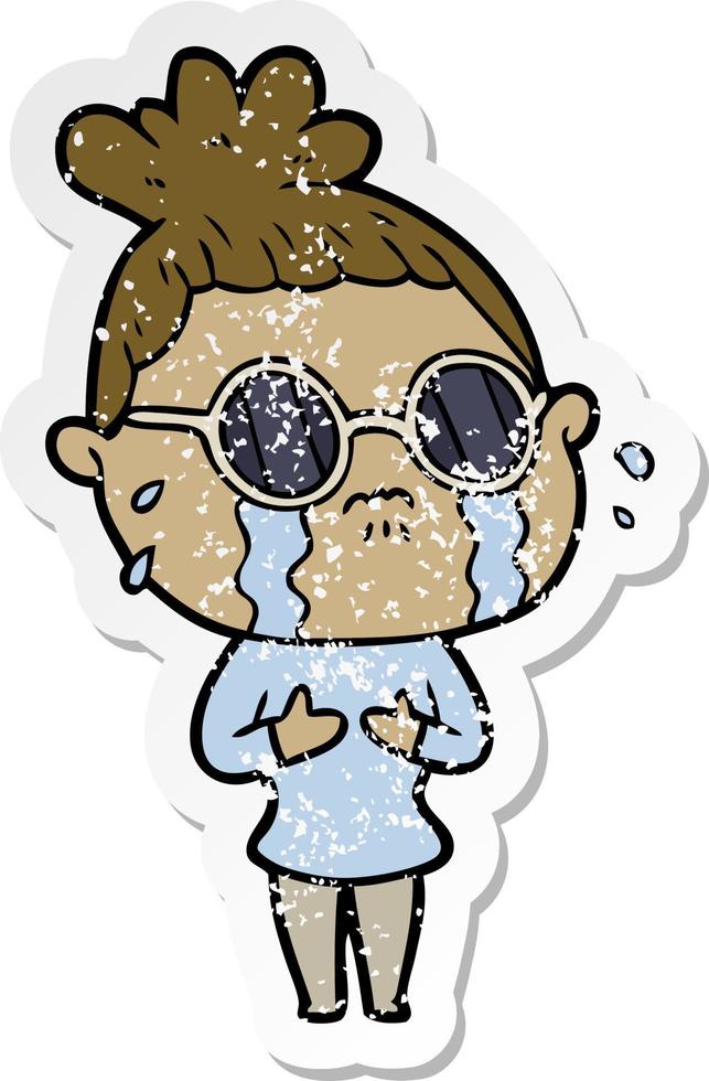 distressed sticker of a cartoon crying woman wearing dark glasses vector
