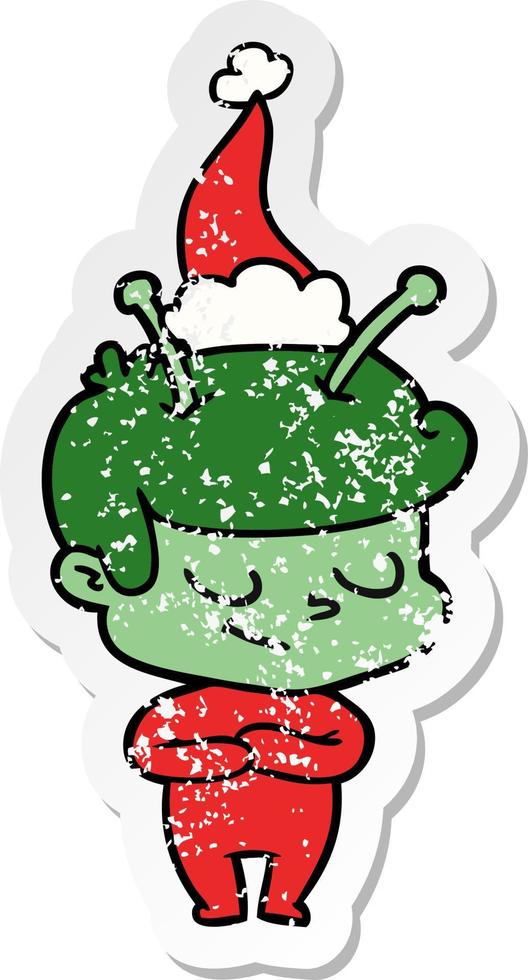 friendly distressed sticker cartoon of a spaceman wearing santa hat vector