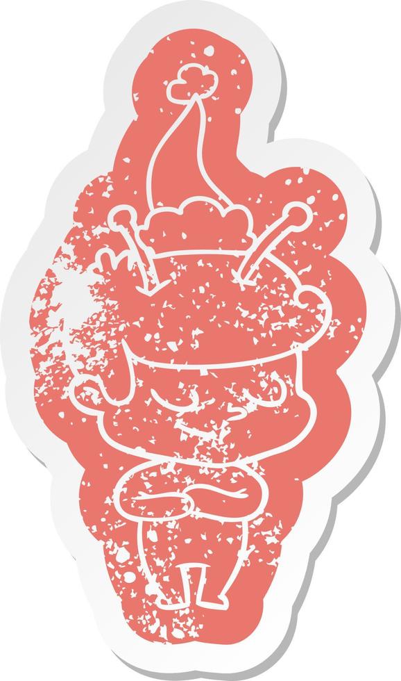 friendly cartoon distressed sticker of a spaceman wearing santa hat vector