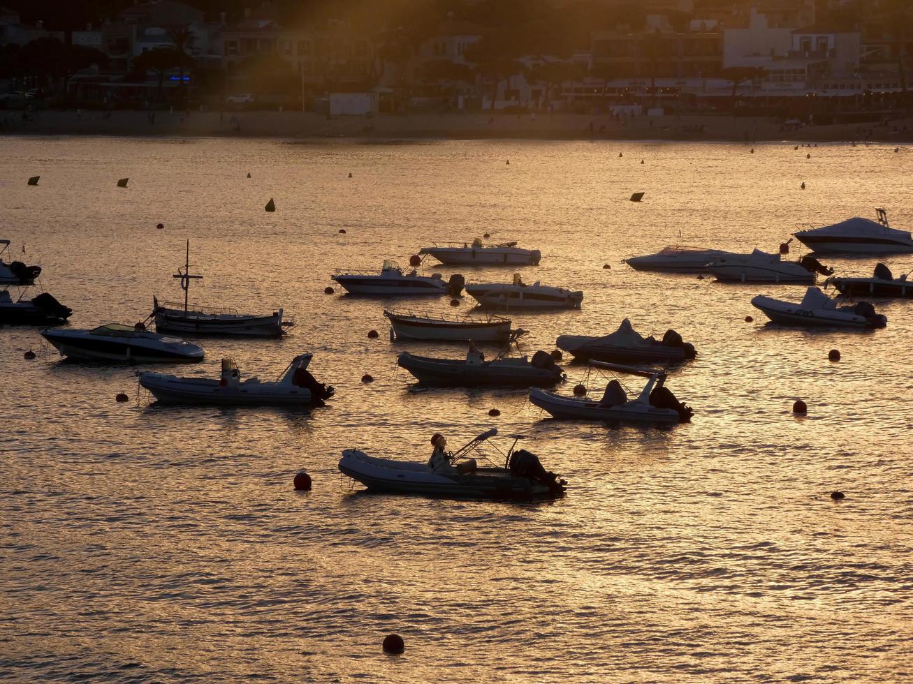 Backlighting of sport boats at anchor in a bay photo