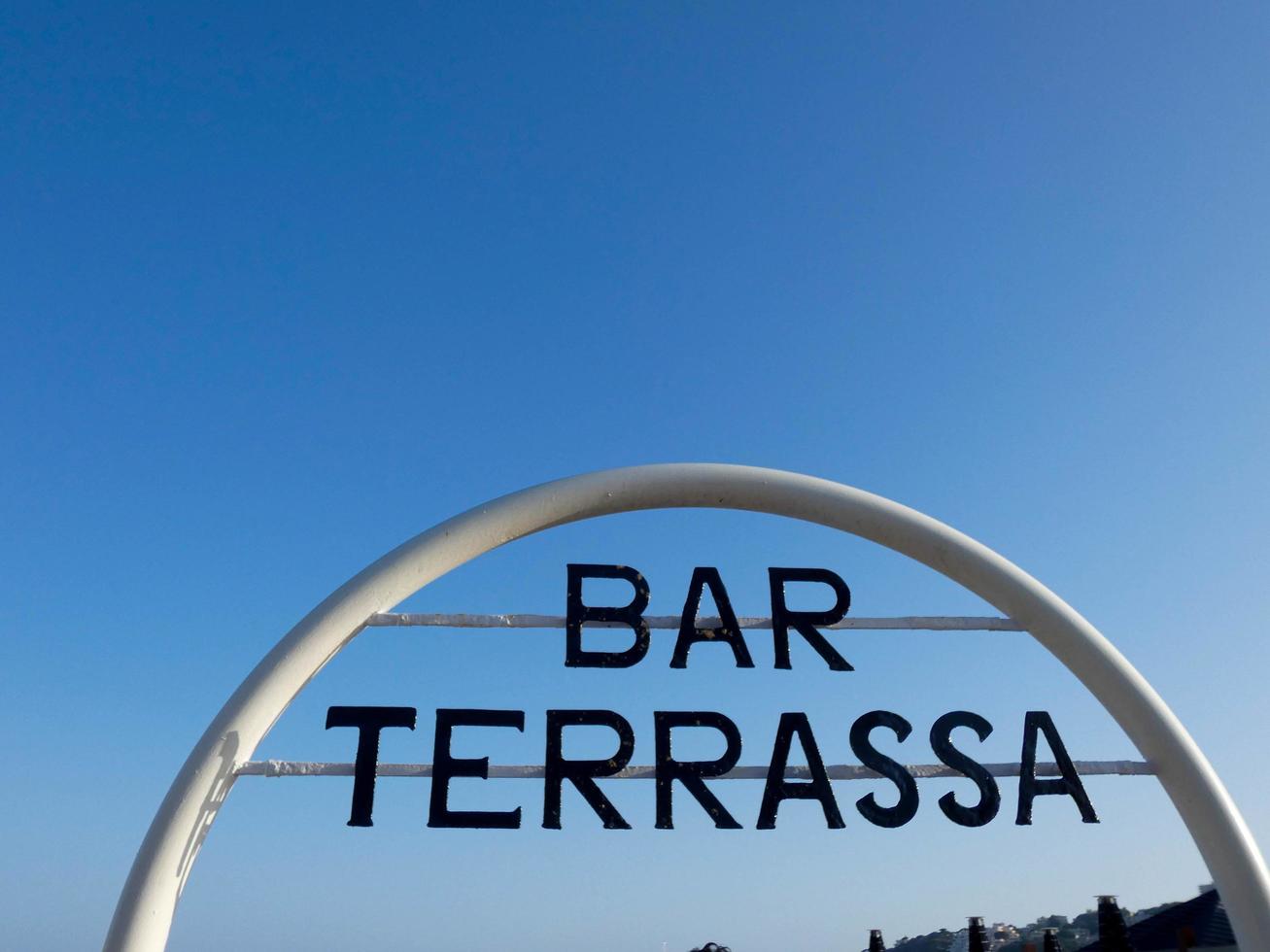 Bar sign, terrace at the door of a bar on the beach photo
