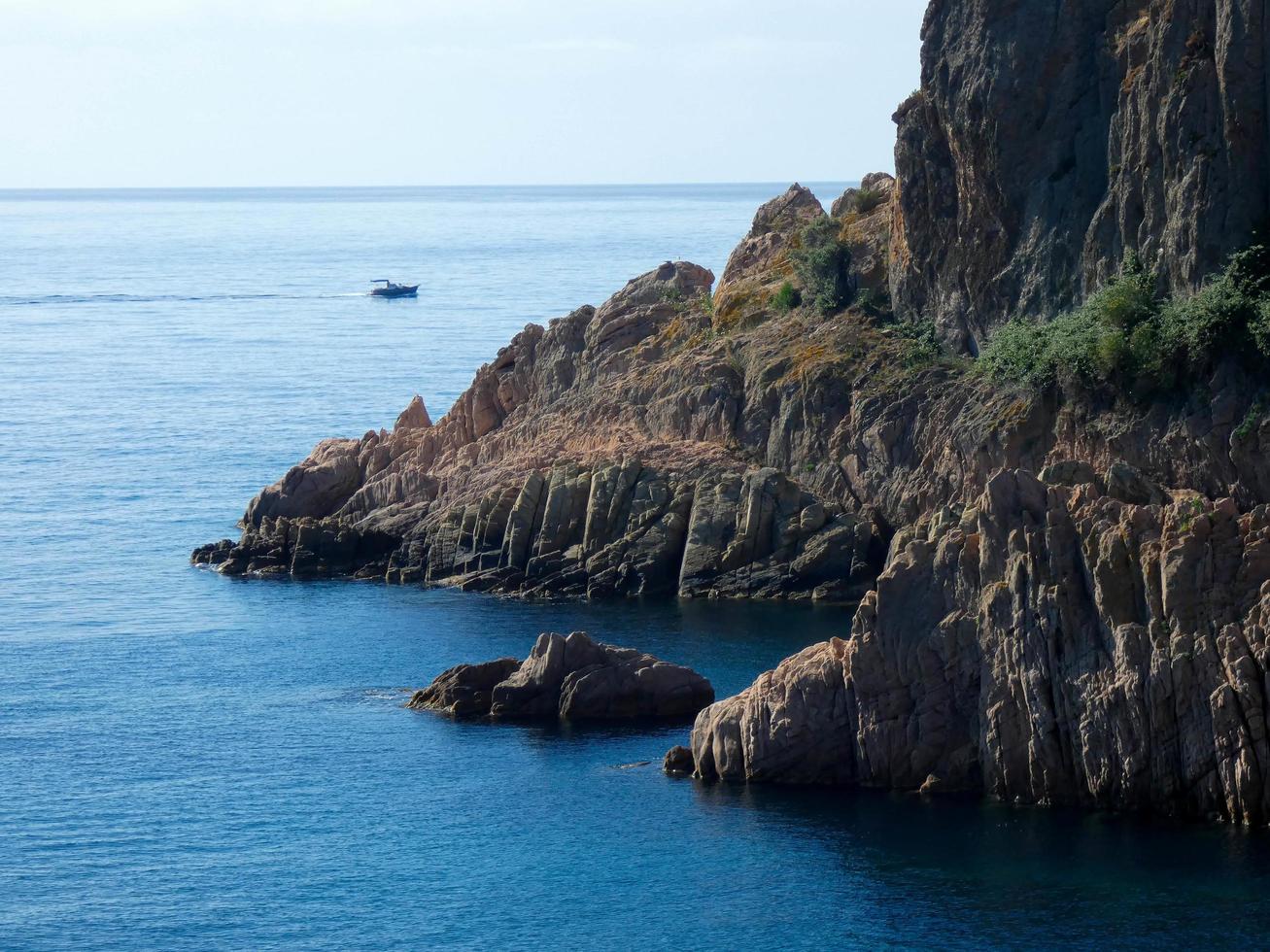 rocks and cliffs with blue sky and turquoise sea photo